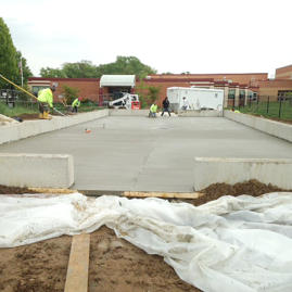 A concrete slab being poured for a building.